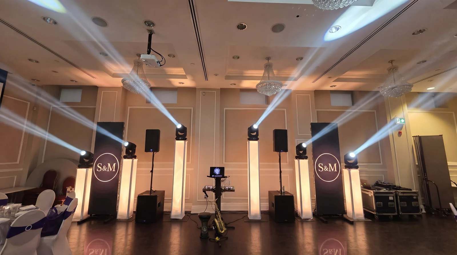 Two tall LED columns either side of the booth showing a couple's monogram, framing the dance floor